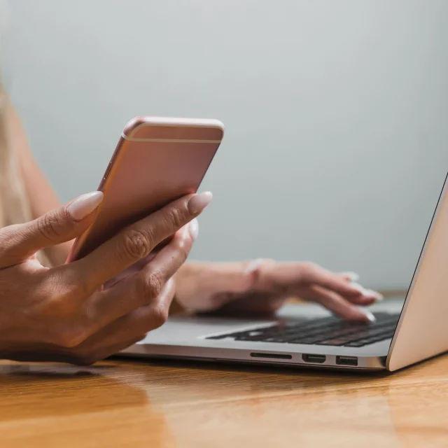 Woman Hands Using Phone Laptop Min